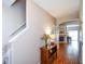 Inviting hallway with hardwood floors, a staircase, and a view of the living room, creating a seamless transition at 904 Magnolia Leaf Dr, Woodstock, GA 30188