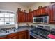 This kitchen features wood cabinets and stainless steel appliances at 904 Magnolia Leaf Dr, Woodstock, GA 30188
