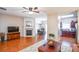 Open-concept living room with a fireplace, hardwood floors, and seamless flow to the dining area and kitchen at 904 Magnolia Leaf Dr, Woodstock, GA 30188