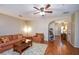 Spacious living room featuring hardwood floors, an archway, and comfortable seating arrangements for a welcoming atmosphere at 904 Magnolia Leaf Dr, Woodstock, GA 30188