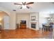 Bright living room with a cozy fireplace, hardwood floors, and an open layout leading to the dining area at 904 Magnolia Leaf Dr, Woodstock, GA 30188