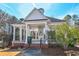 Exterior view of the white pavilion showing brick base, support columns and ceiling fans at 904 Magnolia Leaf Dr, Woodstock, GA 30188