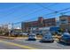 Exterior street view of a mixed-use development with ample parking on a sunny day in a suburban setting at 904 Magnolia Leaf Dr, Woodstock, GA 30188