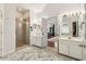 Bright bathroom featuring double sinks, tiled shower, and access to the primary bedroom at 1085 Grace Hadaway Ln, Lawrenceville, GA 30043
