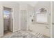 Bright bathroom featuring a tub, tile floors, and a large window at 1085 Grace Hadaway Ln, Lawrenceville, GA 30043