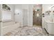 Bright bathroom featuring a tub, tiled shower, white cabinets, and a patterned rug at 1085 Grace Hadaway Ln, Lawrenceville, GA 30043