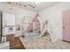 bedroom features a tent bed, playful decor, and hardwood floors at 1085 Grace Hadaway Ln, Lawrenceville, GA 30043