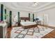 Bright bedroom featuring wood floors, trey ceilings, and a modern colorful rug at 1085 Grace Hadaway Ln, Lawrenceville, GA 30043
