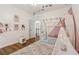 bedroom features a tent bed, playful decor, and hardwood floors at 1085 Grace Hadaway Ln, Lawrenceville, GA 30043