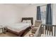 Cozy bedroom features a wooden bed frame, gray armchair, matching crib, and stylish geometric rug at 1085 Grace Hadaway Ln, Lawrenceville, GA 30043