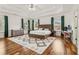 Spacious main bedroom suite with a tray ceiling, large windows, and hardwood floors at 1085 Grace Hadaway Ln, Lawrenceville, GA 30043