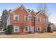A beautiful two-story brick home boasts symmetrical design, pristine landscaping, and inviting front facade at 1085 Grace Hadaway Ln, Lawrenceville, GA 30043