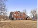 A spacious brick home with a large front yard, featuring symmetrical design, and multiple windows at 1085 Grace Hadaway Ln, Lawrenceville, GA 30043