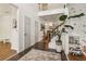Spacious foyer with staircase, plant, and view into the living area, showing off the home's inviting layout at 1085 Grace Hadaway Ln, Lawrenceville, GA 30043
