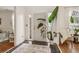 Bright foyer with tile flooring, elegant rug, and a large potted plant, creating a welcoming entrance at 1085 Grace Hadaway Ln, Lawrenceville, GA 30043