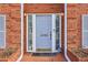 Close-up of the home's front entrance, featuring a stylish door, sidelights, and brick walkway at 1085 Grace Hadaway Ln, Lawrenceville, GA 30043