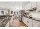 Bright open kitchen with hardwood floors, stainless steel appliances, and granite countertops at 1085 Grace Hadaway Ln, Lawrenceville, GA 30043