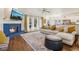Open concept living room with fireplace, white sofa, hardwood floors and view to the kitchen at 1085 Grace Hadaway Ln, Lawrenceville, GA 30043