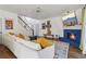Open concept living room featuring a fireplace, white sofa, and staircase at 1085 Grace Hadaway Ln, Lawrenceville, GA 30043