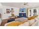 Living room featuring a fireplace, white sofa with yellow pillows, and hardwood floors at 1085 Grace Hadaway Ln, Lawrenceville, GA 30043