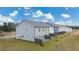 Rear view of townhouses showing exteriors, new lawn and fencing on a sunny day at 52 Leggett Dr # 183, Villa Rica, GA 30180