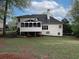 View of the home's backyard, screened in porch, and landscaping at 1514 Haven Crest Dr, Powder Springs, GA 30127