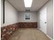 Finished basement area, featuring brick accent, window and door leading to another part of the house at 1514 Haven Crest Dr, Powder Springs, GA 30127