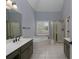 Bright bathroom featuring a double sink vanity, soaking tub, and glass-enclosed shower at 1514 Haven Crest Dr, Powder Springs, GA 30127