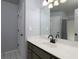 Neutral bathroom featuring a white vanity and a large framed mirror at 1514 Haven Crest Dr, Powder Springs, GA 30127