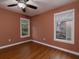 Bedroom with hardwood floors, ceiling fan, and two windows with privacy blinds at 1514 Haven Crest Dr, Powder Springs, GA 30127