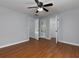 Spacious bedroom featuring wood floors, neutral paint, ceiling fan, and access to bathroom at 1514 Haven Crest Dr, Powder Springs, GA 30127