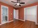 Bedroom with hardwood floors, ceiling fan, closet and en suite bath at 1514 Haven Crest Dr, Powder Springs, GA 30127