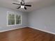 Spacious bedroom featuring wood floors, neutral paint, and a ceiling fan for added comfort at 1514 Haven Crest Dr, Powder Springs, GA 30127