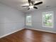 Bedroom with hardwood floors, a ceiling fan, and natural light from two windows at 1514 Haven Crest Dr, Powder Springs, GA 30127