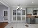 Bright dining area with large windows, stainless steel appliances, and modern chandelier at 1514 Haven Crest Dr, Powder Springs, GA 30127