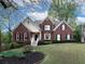 Charming brick home featuring manicured lawn and stylish front entrance at 1514 Haven Crest Dr, Powder Springs, GA 30127
