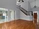 Open-concept living room features hardwood floors, stairs, fireplace, and natural light at 1514 Haven Crest Dr, Powder Springs, GA 30127