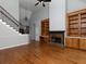 Spacious living room showcases hardwood floors, built-in cabinets, fireplace, and staircase at 1514 Haven Crest Dr, Powder Springs, GA 30127