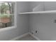 This pantry offers extra storage with built-in shelving and a window bringing in natural light at 1514 Haven Crest Dr, Powder Springs, GA 30127