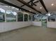 Covered outdoor patio with wooden beams, ceiling fan, and herringbone tile flooring at 1514 Haven Crest Dr, Powder Springs, GA 30127