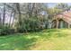 This backyard features lush greenery and a staircase leading to a raised platform or deck, adding charm and accessibility at 1951 Brannen Se Rd, Atlanta, GA 30316