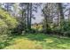 Lush greenery and mature trees create a private and serene outdoor space, perfect for relaxation and enjoying nature at 1951 Brannen Se Rd, Atlanta, GA 30316