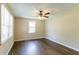 Bright bedroom with hardwood floors, fan, and ample natural light from large windows at 1951 Brannen Se Rd, Atlanta, GA 30316