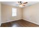 Bedroom features a ceiling fan, hardwood floors, and a window with natural light at 1951 Brannen Se Rd, Atlanta, GA 30316
