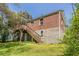 Exterior rear view of a brick home with a wood deck and stairs at 1951 Brannen Se Rd, Atlanta, GA 30316