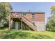 Exterior rear view of a brick home with a wood deck and stairs at 1951 Brannen Se Rd, Atlanta, GA 30316