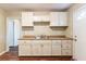 Functional kitchen featuring wood-look floor, laminate countertops, and ample cabinet space at 1951 Brannen Se Rd, Atlanta, GA 30316