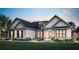 Charming single-story home with a brick facade, accentuated by modern design elements and lush landscaping at 2550 Bertrand Way, Cumming, GA 30041