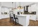 Modern kitchen with white cabinetry, stainless steel appliances, and a sleek island with bar seating at 2550 Bertrand Way, Cumming, GA 30041