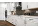 Well-designed kitchen with stainless steel appliances, white cabinets, and sleek countertops with backsplash at 2550 Bertrand Way, Cumming, GA 30041